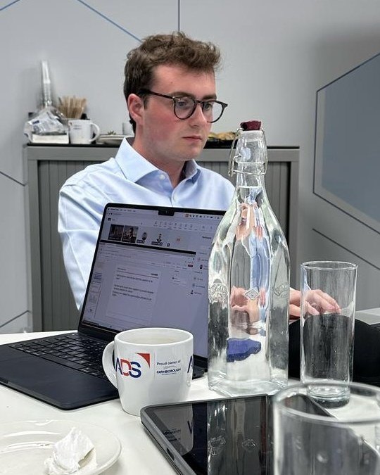 Hugo King working on a laptop at a meeting table